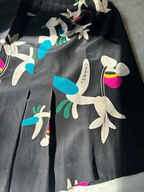 Authentic CHANEL Black Silk Skirt with logo hidden in the floral print